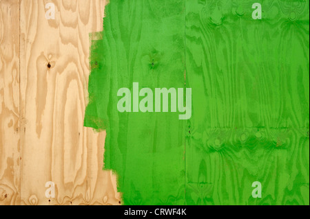 Wooden wall being painted green Stock Photo
