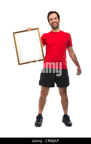 Young sportsman in fitness clothing holding a blank picture frame Stock Photo