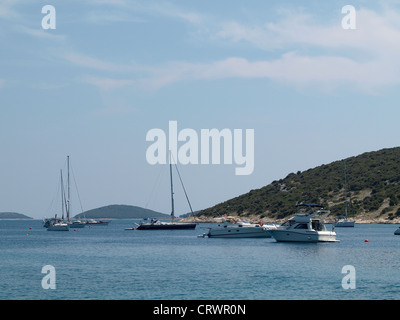 A little sea bay with sailing boats and islands in distance Stock Photo