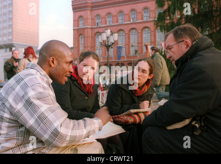 A colored student discusses with his professor Stock Photo