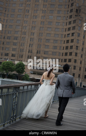Bridegroom and bride have their wedding photographs taken on Waibaidu Bridge steel bridge near the Bund, in Shanghai, China Stock Photo
