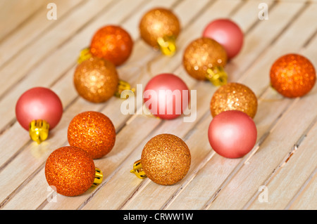 small christmas decorating balls in golden copper and pink colors Stock Photo