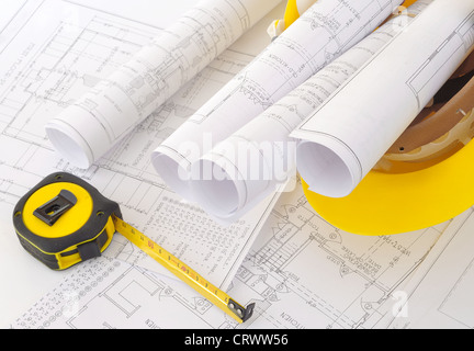 construction plans rolled up in helmet Stock Photo