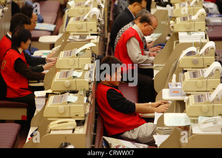 Dealer at work in the Stock Exchange of Hong Kong Stock Photo