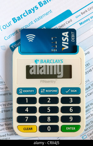 A Barclays passcode authentication PINsentry device reading a chip and pin card to verify identity. On Barclays bank statements. Stock Photo