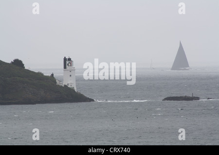 J Class yacht with St Anthony's Lighthouse in the foreground viewed from St Mawes during the J Class Regatta, Falmouth June 2012 Stock Photo