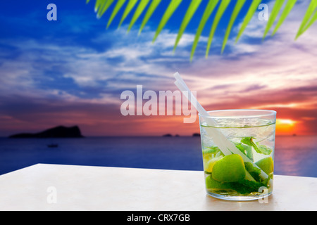 Ibiza cala Conta Conmte sunset with Mojito drink cocktail Stock Photo