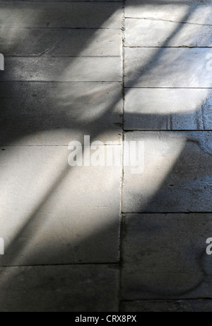 The reflection of an arched window on a flagstone floor Stock Photo