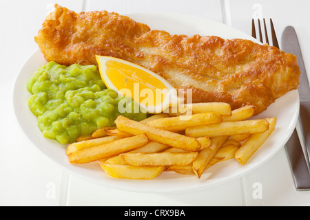 Battered fish served with chips and mushy peas Stock Photo