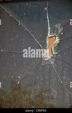 Window glass damaged by bullets Stock Photo