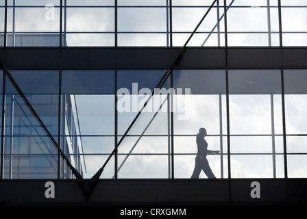 A woman in the glass transition between Buerogebaeuden Stock Photo