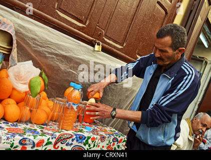 Man selling fresh orange juice in Fes medina, Morocco Stock Photo