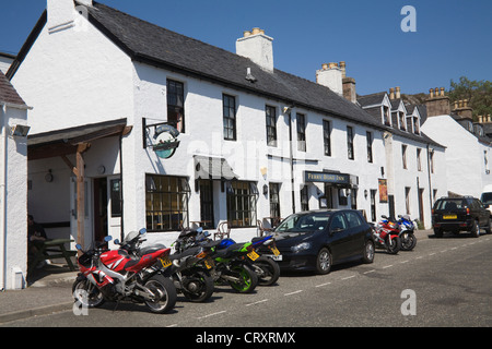 Ullapool Ross and Cromarty Scotland UK Motorbikes and cars parked outside the popular Ferry Boat Inn on a lovely May summers day weather Stock Photo