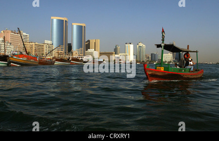 A water taxi to the Dubai Creek against the skyline of the old town of Dubai Stock Photo