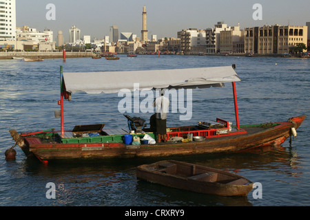 A water taxi to the Dubai Creek against the skyline of the old town of Dubai Stock Photo