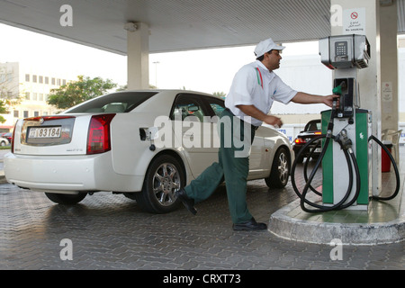 Attendant refueling a car at a gas station, Dubai Stock Photo