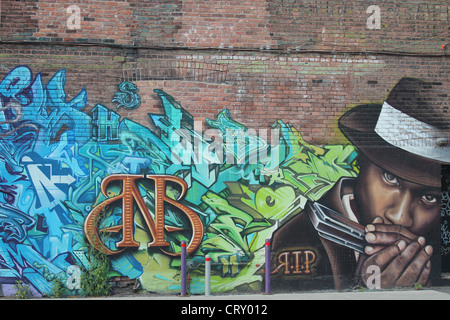Wall Graffiti art on brick wall Stock Photo