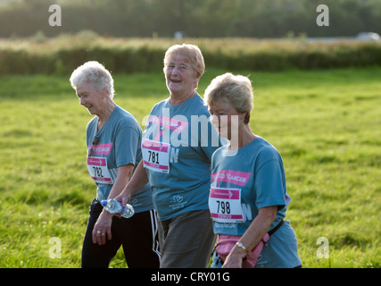 Women walking in the Race for Life at Stratford Racecourse. Stock Photo