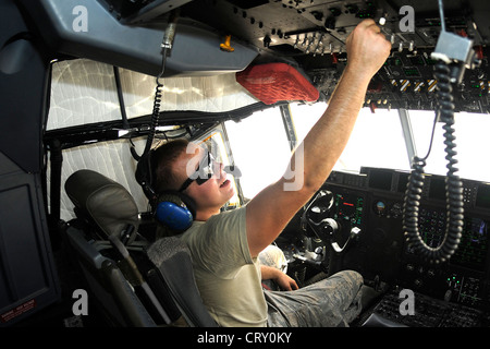 Airman 1st Class Custer Back, a C-130 crew chief from the 317th Aircraft Maintenance Squadron at Dyess Air Force Base, Texas, currently assigned to the 451st AMXS at Kandahar Airfield, Afghanistan, checks gauges while the aircraft is refueled on July 4, 2012. Stock Photo