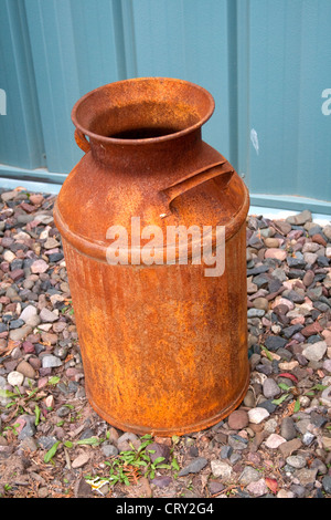 Rusted antique old farm milk can. Business and Industrial Park. Shell Lake Wisconsin WI USA Stock Photo