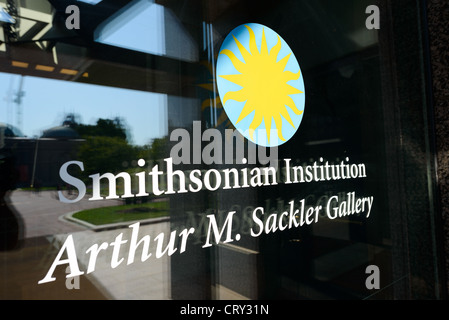 WASHINGTON DC, USA - Sackler Gallery Sign on Glass. The Arthur M. Sackler Gallery, located behind the Smithsonian Castle, showcases ancient and contemporary Asian art. The gallery was founded in 1982 after a major gift of artifacts and funding by Arthur M. Sackler. It is run by the Smithsonian Institution. Stock Photo