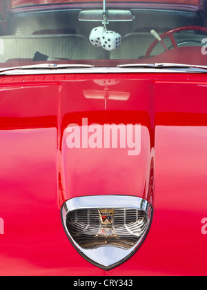 1950’s Classic Car Detail on red glossy Ford Fairlane Skyliner American classic motor car with furry dice hanging in windscreen window Stock Photo