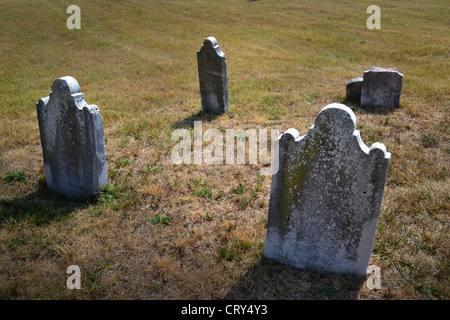 Grave yard with grave stones sitting alone on a hillside Stock Photo