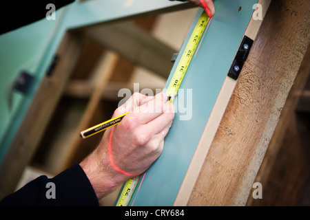 Builders using cross line laser Stock Photo