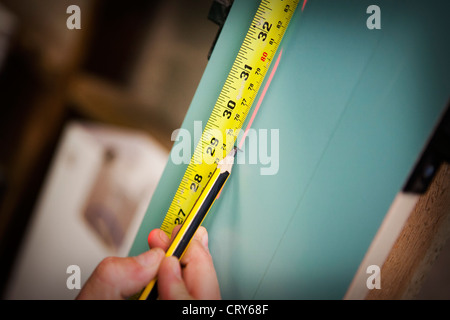 Builders using cross line laser Stock Photo