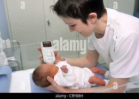 Newborn / new born baby undergoes neonatal heel prick screening Stock ...