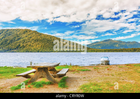 Table for picnic on lakeside in New Zealand. Stock Photo