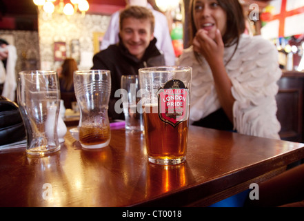 People drinking Fullers London Pride beer in the interior of the Duke of York pub, Victoria, London UK Stock Photo