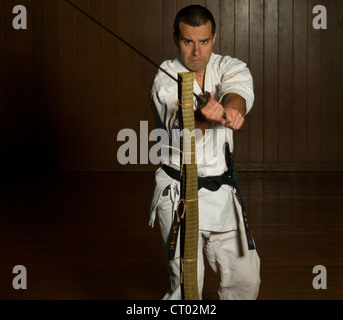 Iaido Tameshigiri training. Slicing rolled tatami matting with a katana ( samurai sword ). Stock Photo