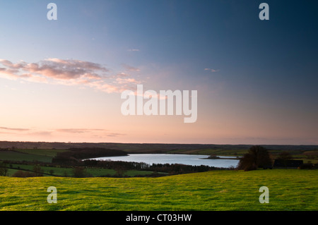 A view of Eyebrook Reservoir just after sunrise in January, from high ground near the village of Stoke Dry in Rutland, England Stock Photo