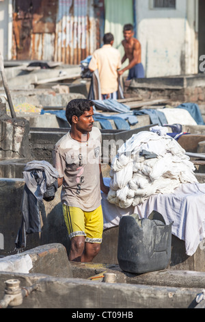 Dhobi wallahs working with laundry at Dhobi Ghat, Mumbai, India Stock Photo