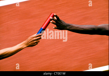 Detail of track and field relay baton pass. Stock Photo