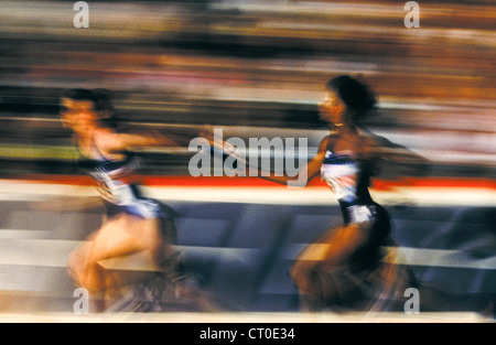 Track and field relay baton pass. Stock Photo