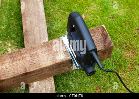 Jigsaw tool cutting a piece of wood on  Stock Photo