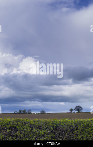 Storm clouds in cloud formation above ploughed field in springtime in Swinbrook in the Cotswolds, Oxfordshire, UK Stock Photo