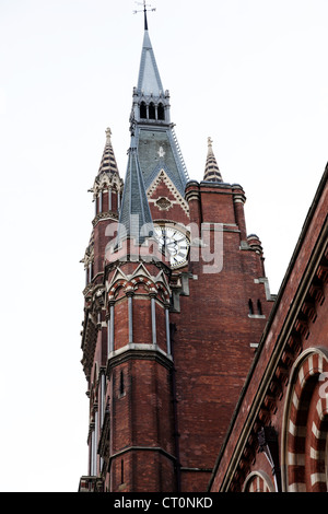 It's a photo of Saint Pancras building Eurostar station London UK England. We can see the big Clock and the bricks of its tower Stock Photo