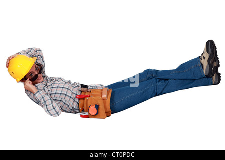 Female builder in sunglasses laying down Stock Photo