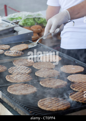 Hamburgers being cooked on the hot grill Stock Photo