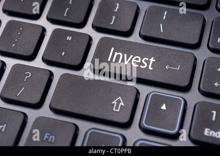 invest or investing concepts, with a message on enter key or keyboard. Stock Photo