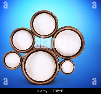 Abstract design of round shapes in the form of beer barrels on a blue background. Inside the barrels textured watercolor paper. Stock Photo