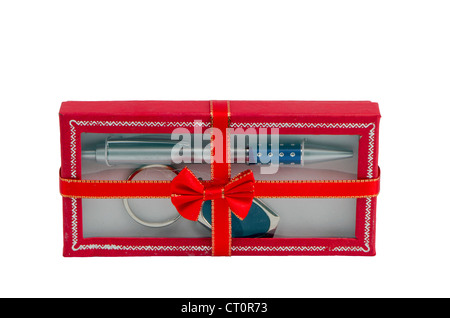 Pen and key ring packed in red gift box with ribbon isolated on white background. Stock Photo