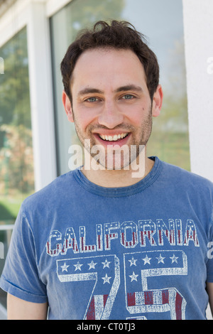Smiling man standing outdoors Stock Photo