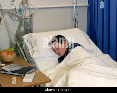 Boy sleeping in hospital bed Stock Photo