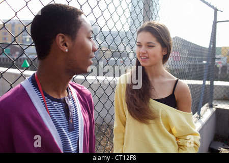 Couple talking on city street Stock Photo
