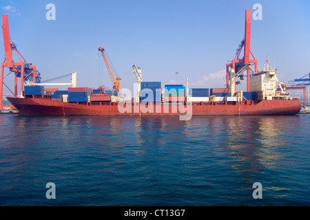 Container barge in urban bay Stock Photo