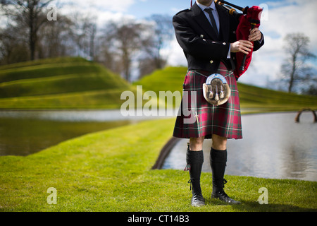 Man in Scottish kilt playing bagpipes Stock Photo